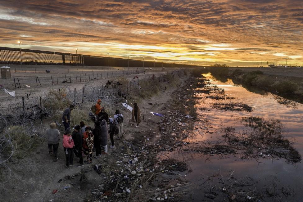 Migrants cross the Rio Grande