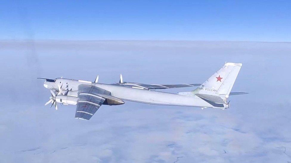 A Russian Tu-95MS strategic bomber performs a flight over the neutral waters of the Bering Sea, in this still image taken from a handout video released February 14, 2023