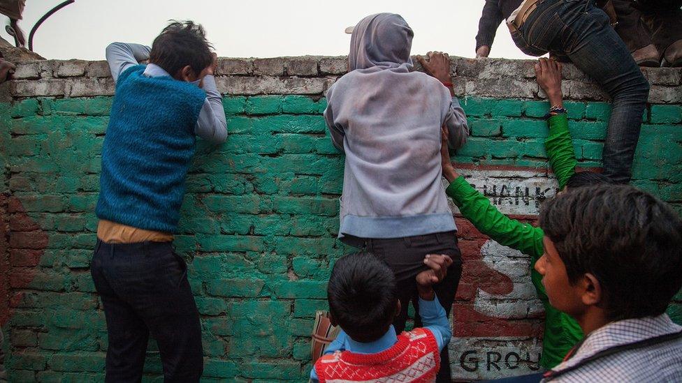 Children try to watch the sacrifices at the Gadhimai temple in Nepal (Nov 2014)