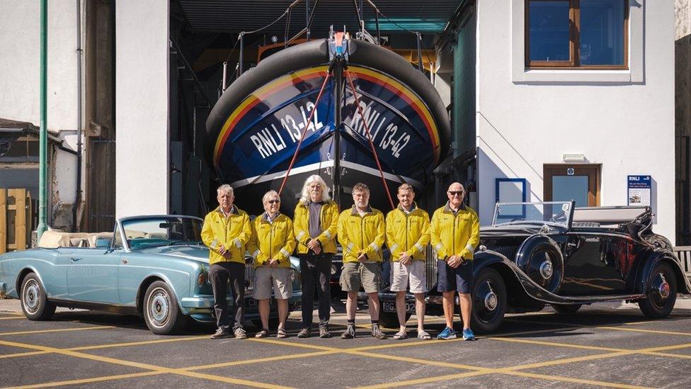 Classic cars outside the Ramsey Lifeboat Station along with crew members