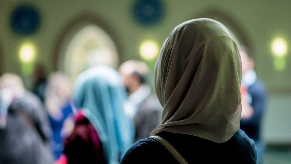 Muslim women stand in the Aya Sofya mosque on October 3rd, 2016 in Hanover, northern Germany, as visitors attend the Open-Mosque-Day