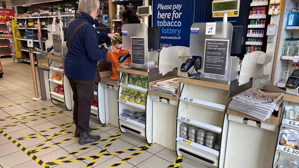 Taped-off areas for customers distance themselves from each other are seen at the checkout till area of a local Tesco store as the number of coronavirus disease cases (COVID-19) grow around the world, in London, Britain, March 21, 2020. REUTERS/Toby Melville