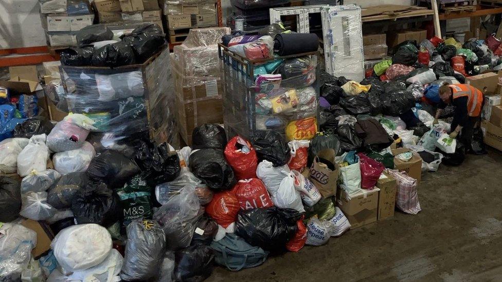 Piles of donations in bags and boxes at the Island Express warehouse