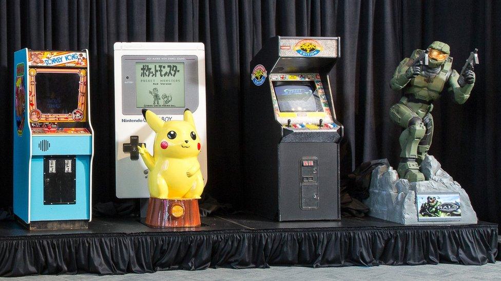 Donkey Kong arcade console, Pokemon's Pikachu in front of a giant Game Boy, Street Fighter II arcade console, and life size Halo figurine