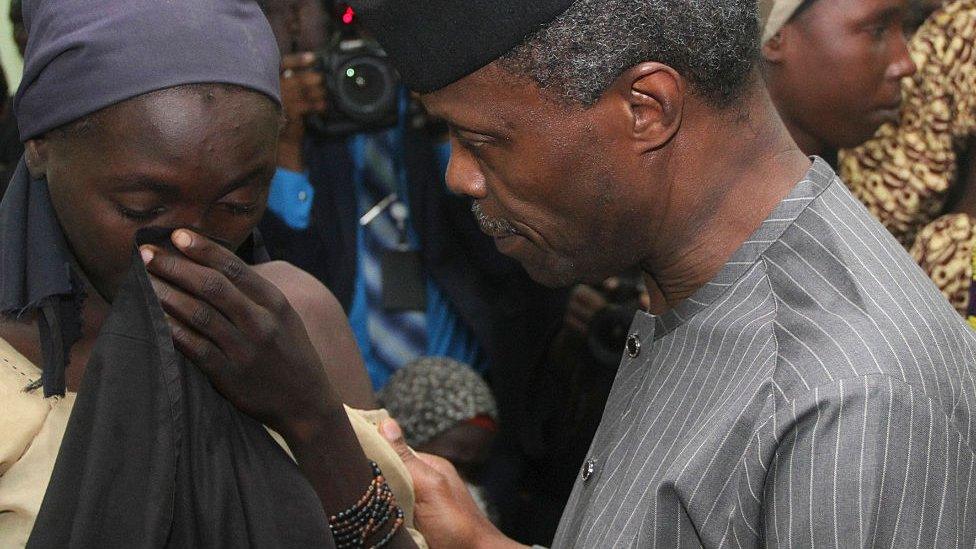 Yemi Osinbajo comforting a girl after her detention by Boko Haram militants