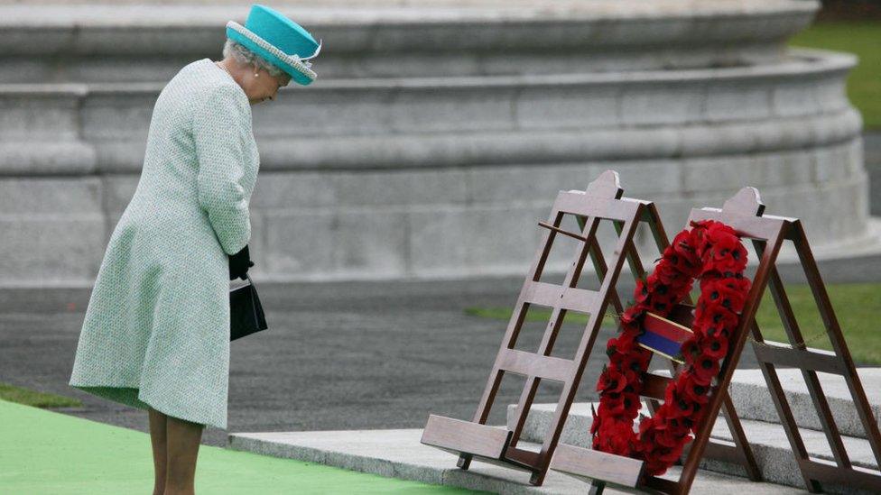 Queen Elizabeth bowing her head at the Irish National War Memorial Garden in Dublin