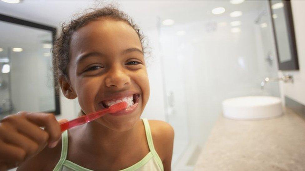 child brushing teeth