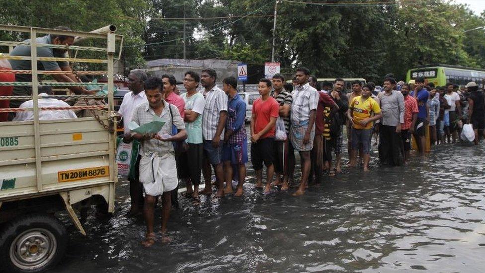 Flood affected people queue up for food in Chennai, India, Thursday, Dec. 3, 2015