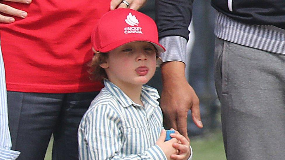 Hadrien sticking his tongue out at his brother Xavier while playing cricket