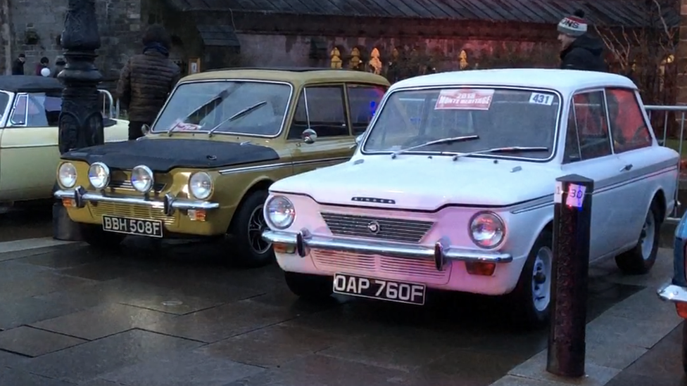 Two cars competing in the rally on display