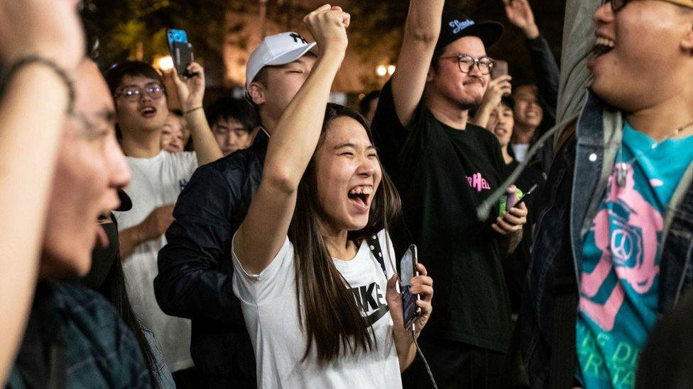 Pro-democracy supporters chant as they celebrate after pro-Beijing candidate Junius Ho lost a seat in the district council elections in Tuen Mun district of Hong Kong, 25 November, 2019