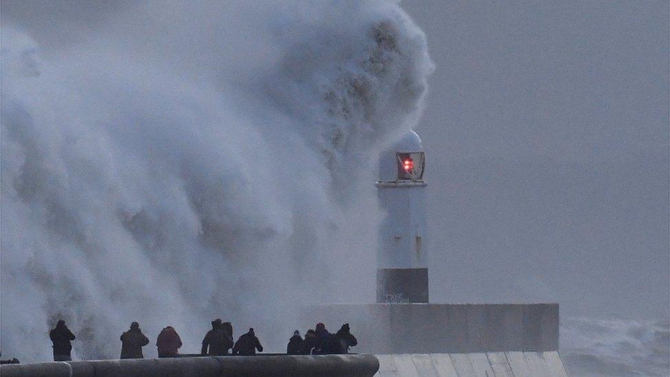 waves crash against a sea wall in Aberystwyth