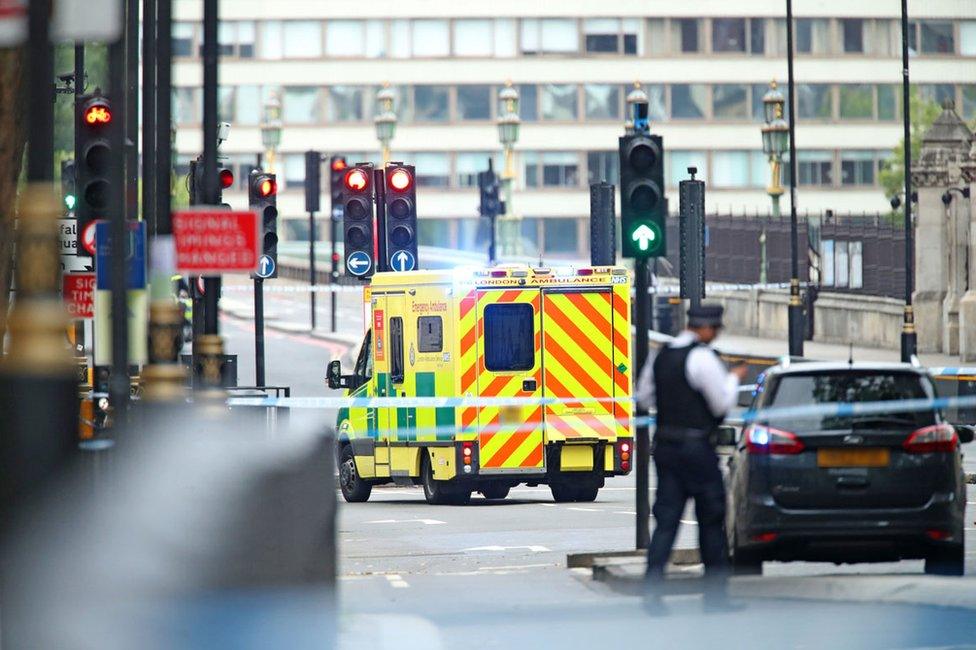 An ambulance near the Houses of Parliament, Westminster in central London, after a car crashed into security barriers outside the Houses of Parliament