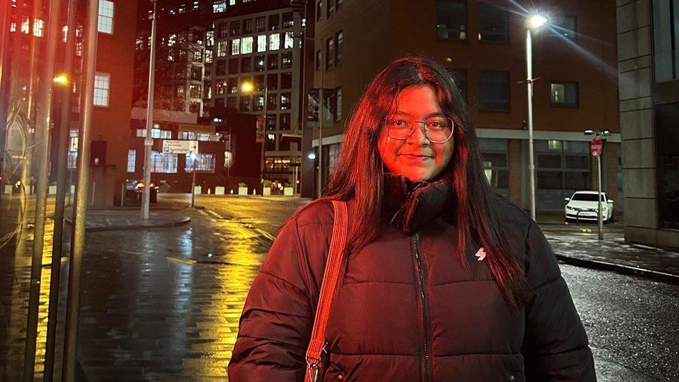 Medha standing in a street