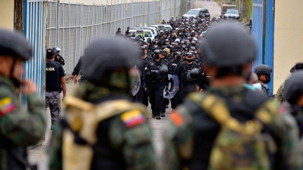 Ecuadorean soldiers and policemen take positions outside of the Regional 8 prison, next to the penitentiary, in the outskirts of Guayaquil, Ecuador, on October 2, 2021.