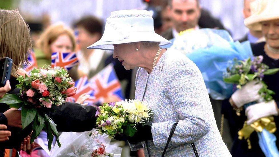 Queen Elizabeth II greets the crowd in Ballinamallard, County Fermanagh, during the first full day of her Golden Jubilee tour of Northern Ireland in 2002