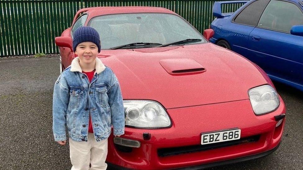 Carterjay Robins standing beside a car