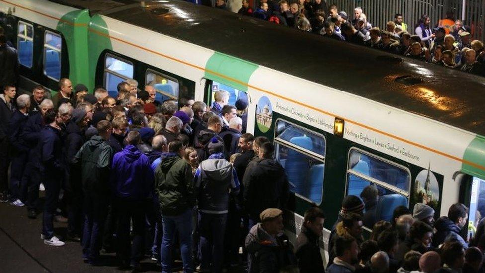 Football supporters boarding a Southern service