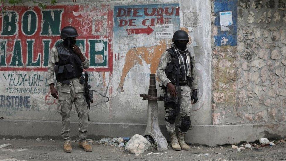 Members of the Haitian National Police patrol a street as ongoing gun battles between rival gangs have forced residents to flee their homes, in Port-Au-Prince, Haiti April 28, 2022