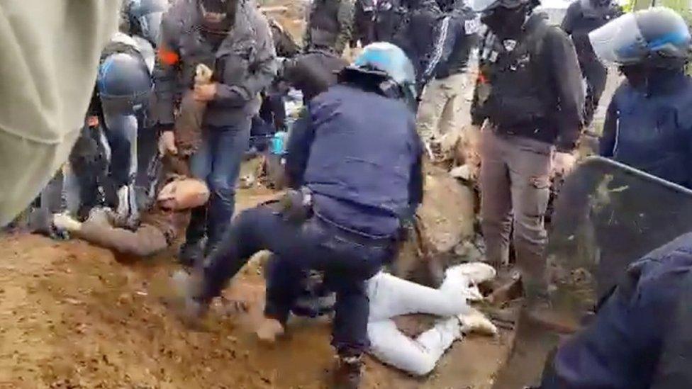 Video from an Amazon protest in Lyon shows police in riot helmets dragging away activists