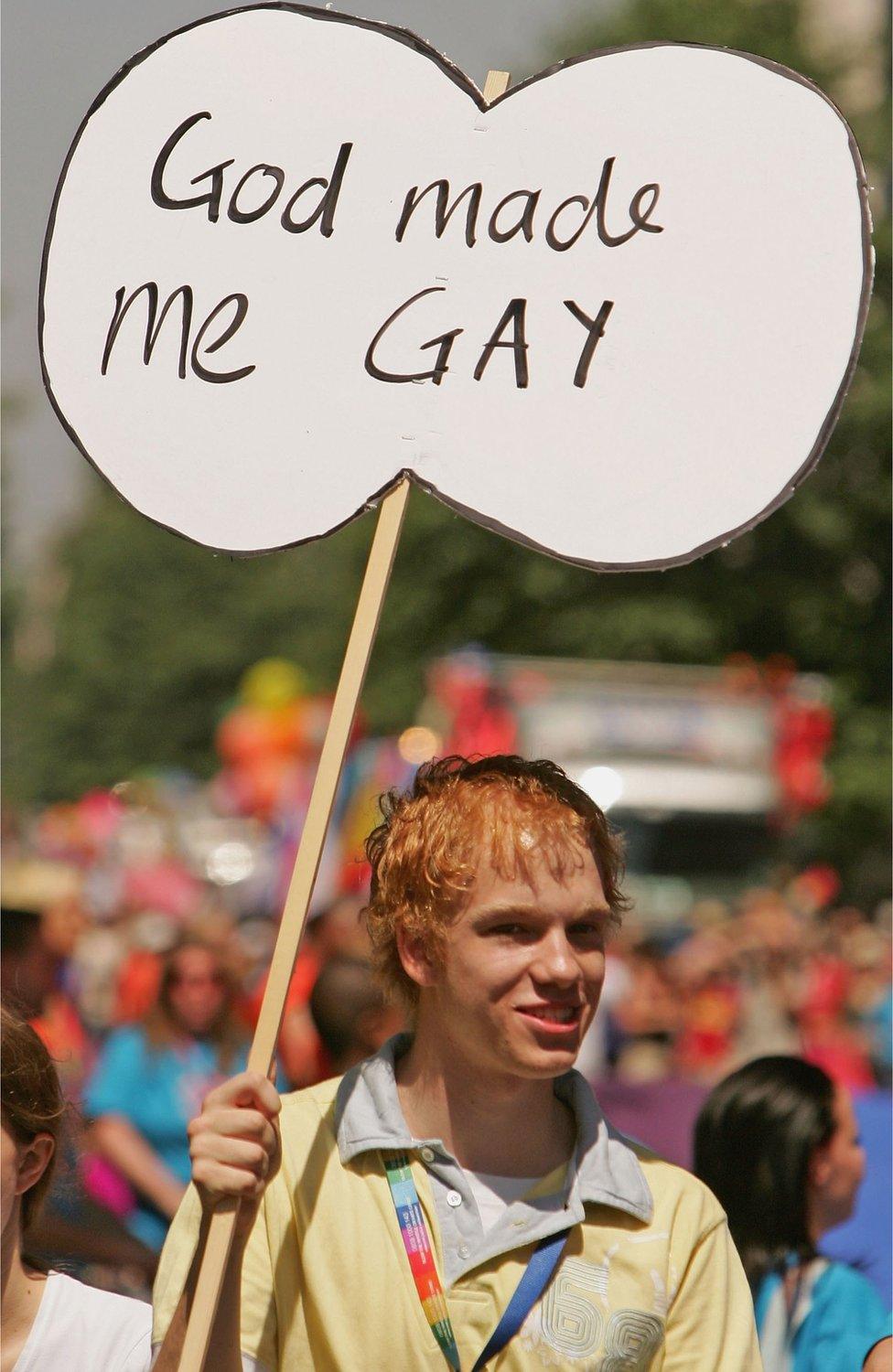 Man with "God made me gay" sign