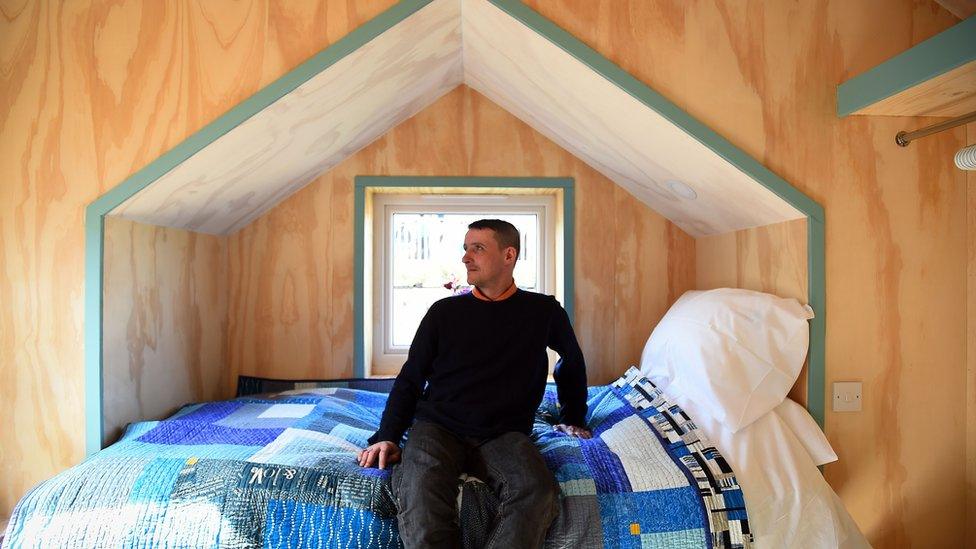 Social Bite worker, Sonny Murray, who was homeless, has a look around the newly completed village buildings during the launch of the Social Bite Village project in Granton, Edinburgh in Scotland on May 17, 2018.