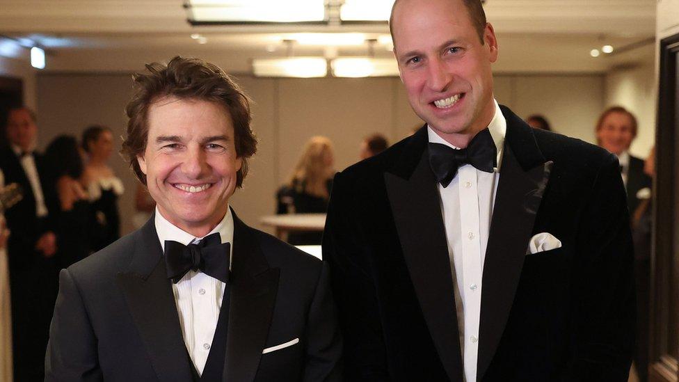 Tom Cruise standing alongside Prince William