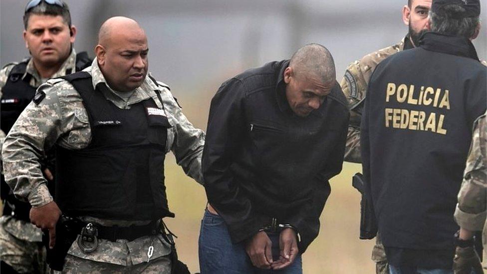 Federal Police agents escort Adélio Bispo de Oliveira at Francisco Alvares de Assis airport in Juiz de Fora, Brazil, 8 September 2018