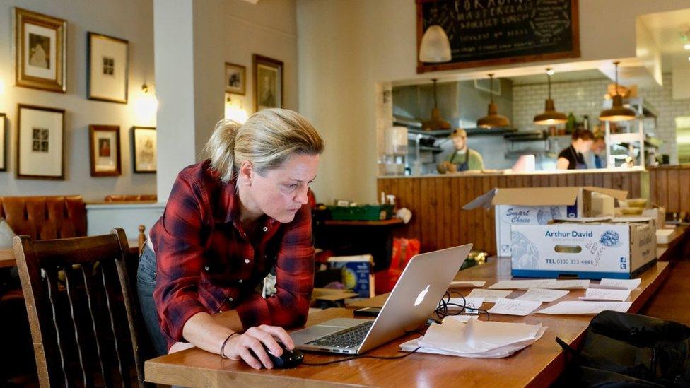 A woman on her laptop in a restaurant