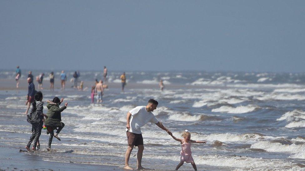 girl-jumping-waves-in-sea