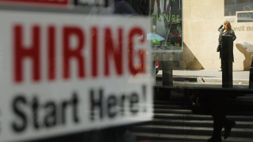 A now hiring sign is displayed in the window of a Brooklyn business on October 5, 2018 in New York, United States.