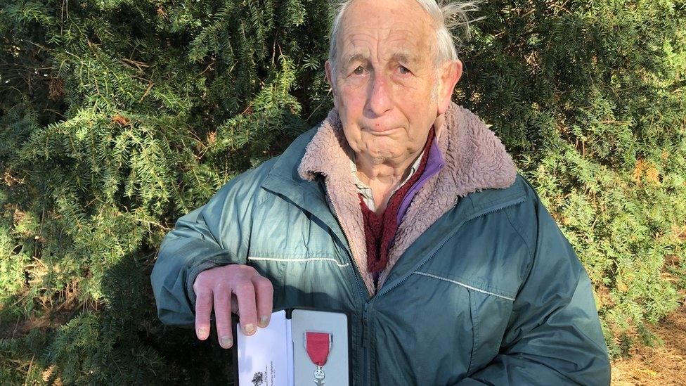 Alan Stubbs holding an MBE award