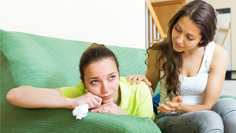 A young person supporting another who is upset