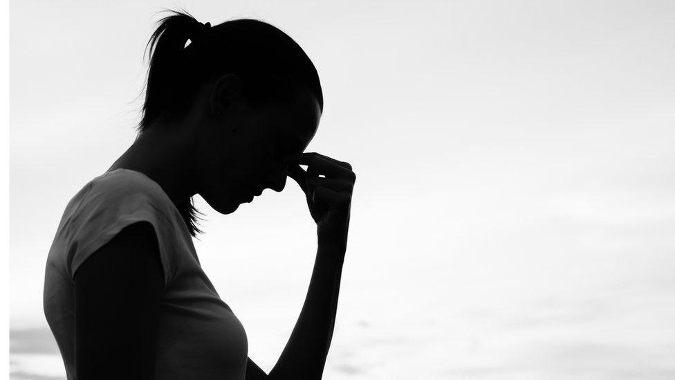 A young woman in silhouette