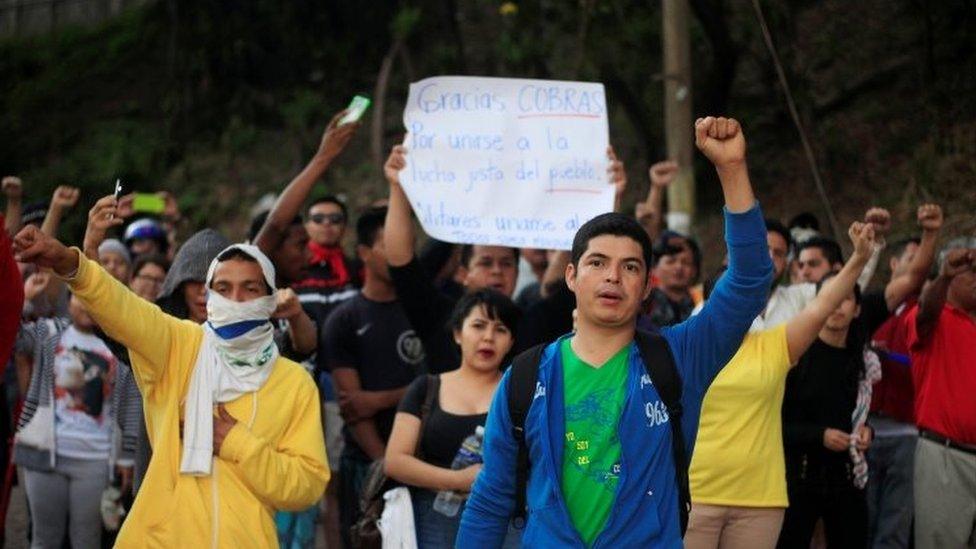 People support Honduran police during a strike to demand higher wages and rest after working extra hours due protests caused by the delayed in vote counting in the general election, at their headquarters in Tegucigalpa, Honduras, December 4, 2017