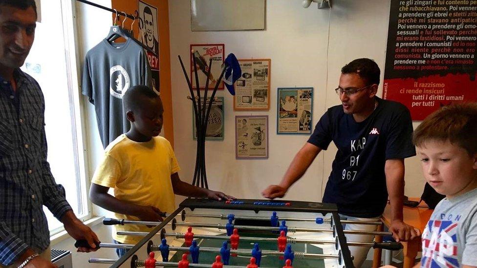 Migrants at a volunteer club in Udine