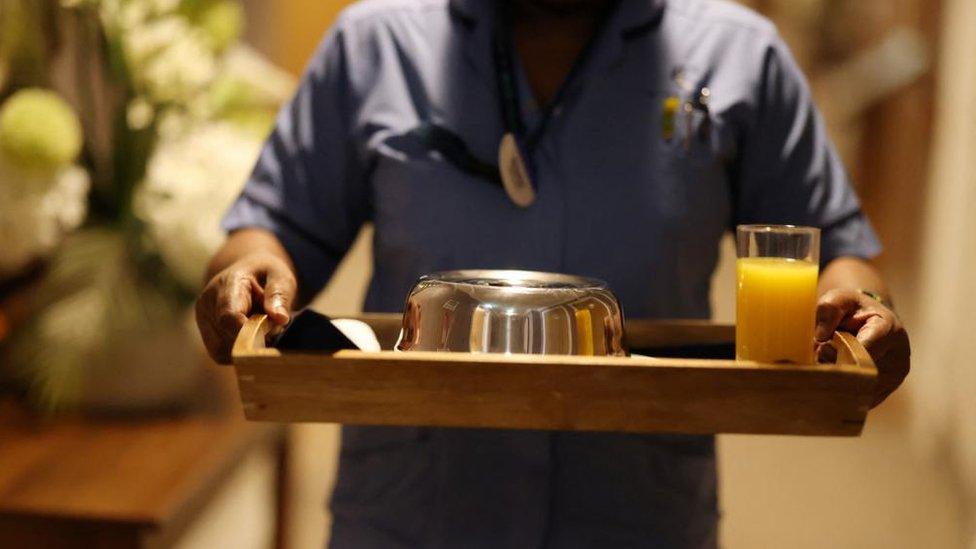 Care home staff carrying tray