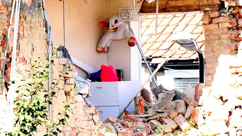 Soft toys and a lamppost are seen in an exposed room of a property in Galpin's Road in Thornton Heath, south London