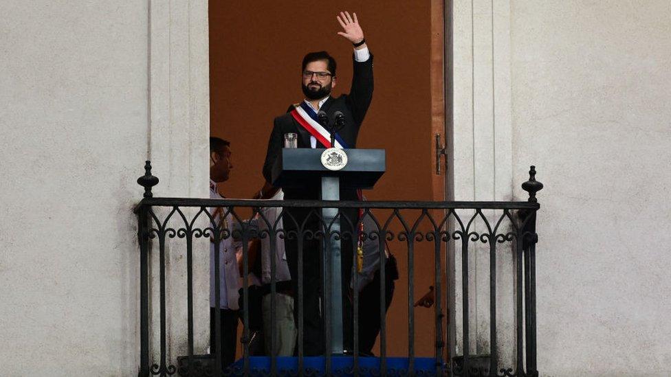 Chile's new President Gabriel Boric greets his supporters before delivering a speech at La Moneda Palace in Santiago, on March 11, 2022