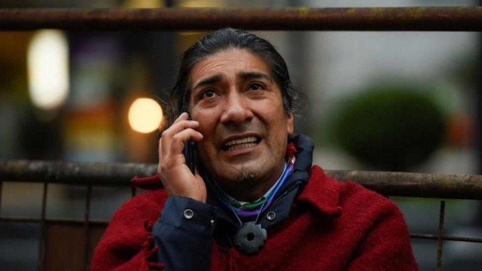 Yaku Perez speaks on a mobile phone outside a hotel, in Quito, Ecuador February 8, 2021.