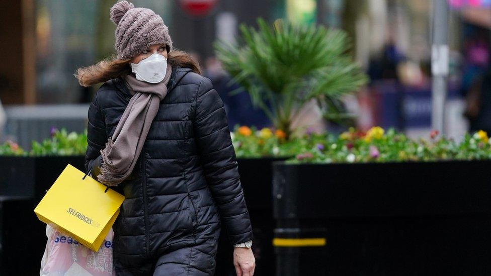 Shopper wears a face covering 2021