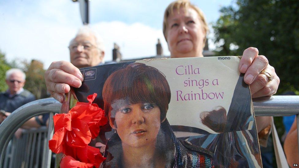 Fans outside church