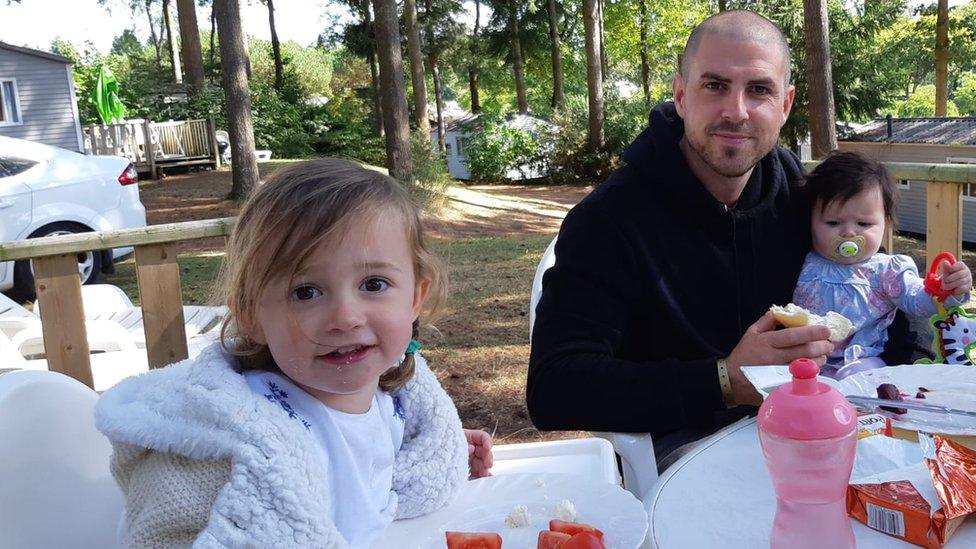 Angharad Carrington-Edmunds' husband and children sitting at a table to eat