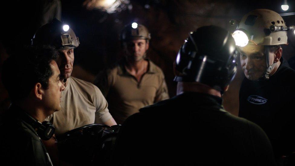 Writer/director Tom Waller briefs his cast on the set of The Cave