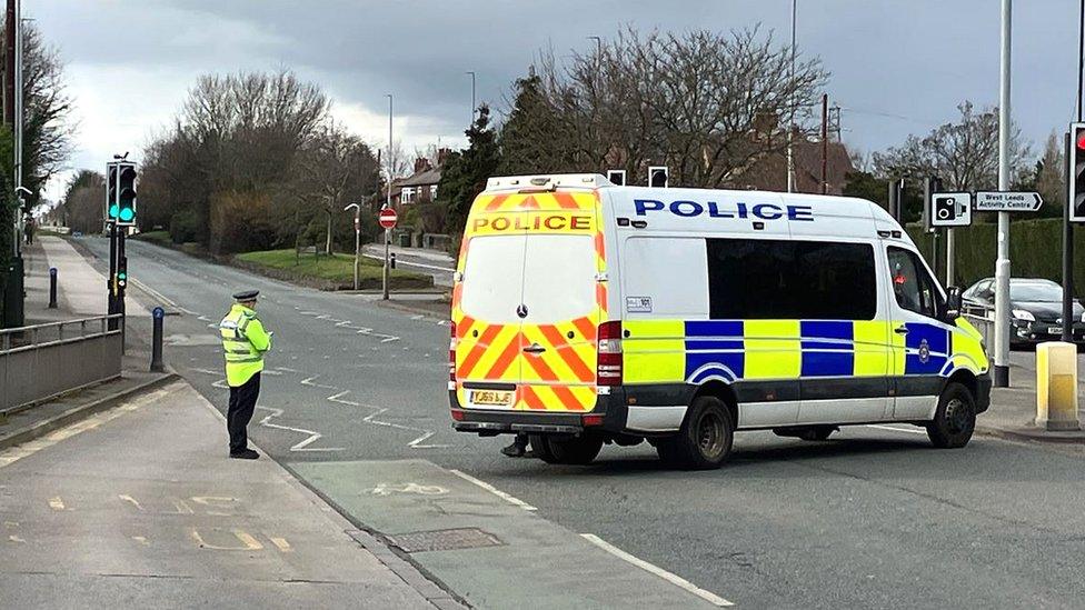 Police officer and van at scene of crash