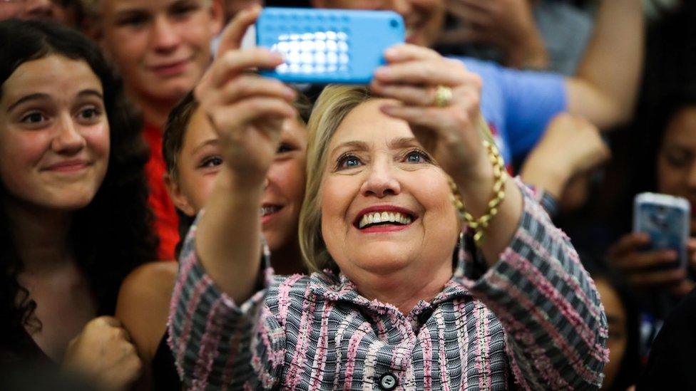 Democratic presidential candidate Hillary Clinton takes photographs with supporters after a campaign rally at Sacramento City College on 5 June 2016 in Sacramento, California.