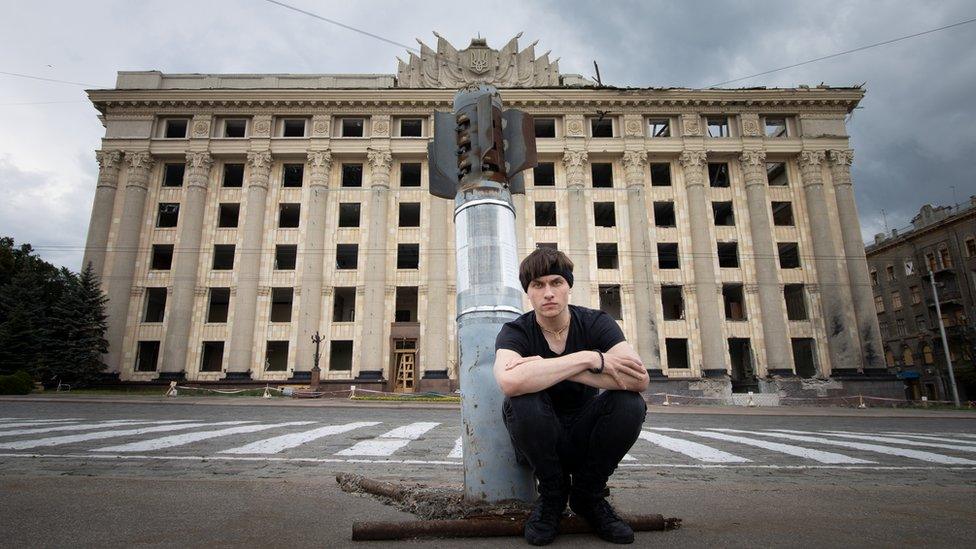 Oleksii with an unexploded bomb