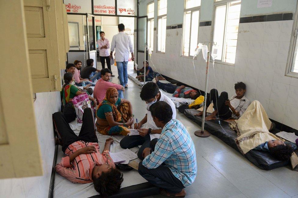 Doctors treating patients in on the floor of a hospital in Delhi