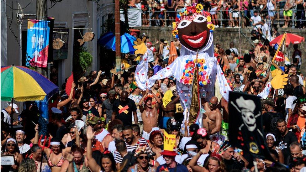 People dancing and parading in the street