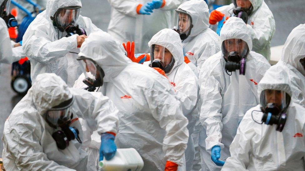 Members of a Servpro cleaning put on protective gear before entering the Life Care Centre of Kirkland, a long-term care facility linked to several confirmed coronavirus cases, in Kirkland, Washington, U.S